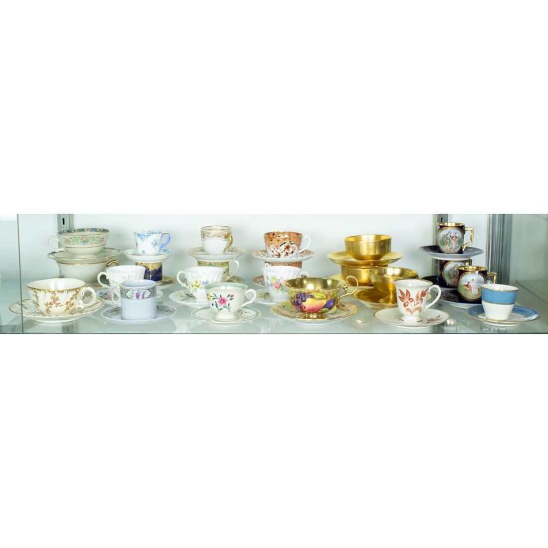 A group of French faience: A group of French faience, consisting of (6) pot de creme with covers; (6) cups and (11) saucers, together with (6) Booths England ceramic cups and (9) saucers in the 'Caroline' pattern. Provenance: P