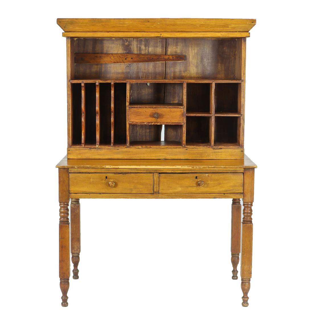 A Primitive pine work desk circa 1800: A Primitive pine work desk circa 1800, the superstructure having a fitted interior resting on the lower two drawer case and rising on block and turned legs, 57"h x 39"w x 21.5"d