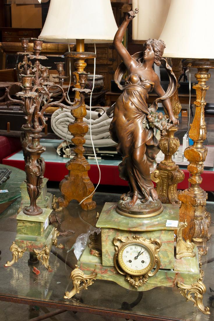 French onyx, patinated and gilt metal figural clock: French onyx, patinated and gilt metal figural clock garniture, modeled as a muse allegorical of Autumn after Auguste Moreau, raised on an outstepped plinth enclosing a clock, flanked by pair of five l
