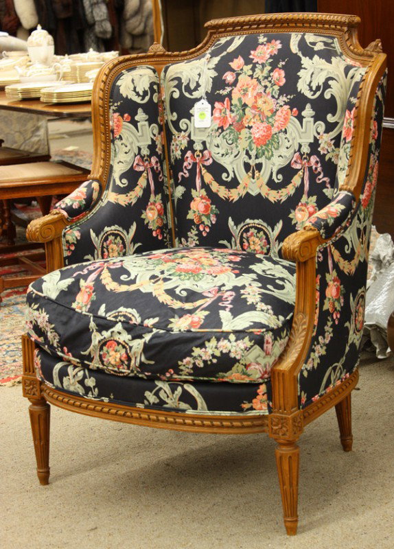 French walnut bergere: French walnut Bergere, Lyon, circa 1890, having a graduated crestrail continuing to the acanthus carved arms and rising on fluted legs, retains a down filled cushion, 41.5''h x 21.5''w