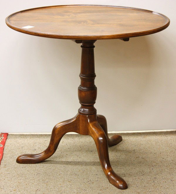 Chippendale style tea table: Chippendale style walnut tea table, having a circular dished top above the turned standard and rising on a tripod base terminating on pad feet, 26.5''h x 27.5''w