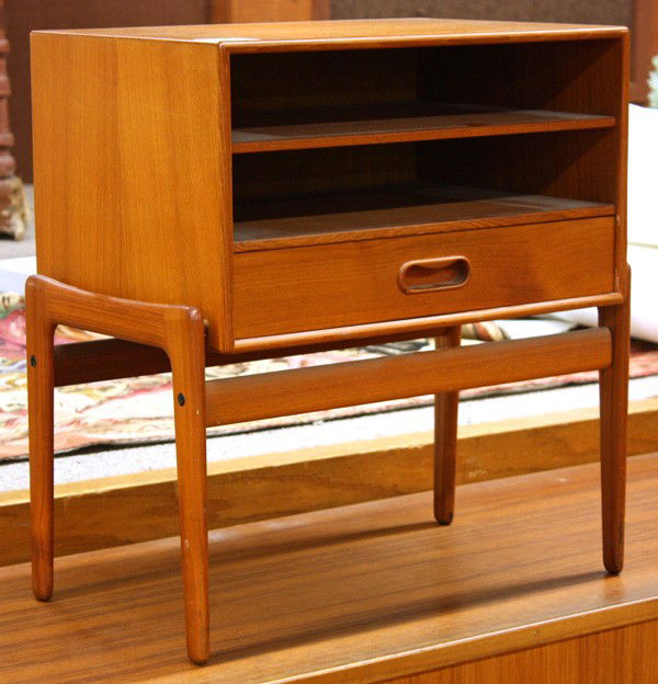 Danish teak side storage unit: Danish teak side storage unit, circa 1970, the top with two shelves below and a single drawer, raised on a teak frame, with tapered legs, 20''h x 19''w x 12''d