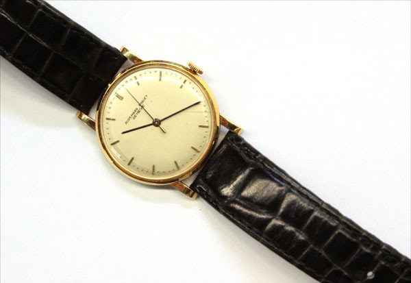 Watch, Audemars Piguet: Gentleman's yellow gold Audemars Piguet wristwatch; with baton chapters, and sweep seconds hand, completed by a black leather strap with metal buckle