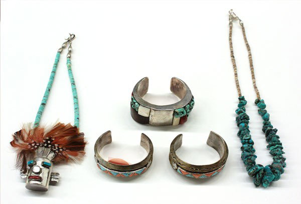 Native American Jewelry: (lot of 5) Native American jewelry items, including; two cuff bracelets inset with turquoise and coral, a silver cuff bracelet set with turquoise, coral, wood, abalone, etc, and having impressed eagle