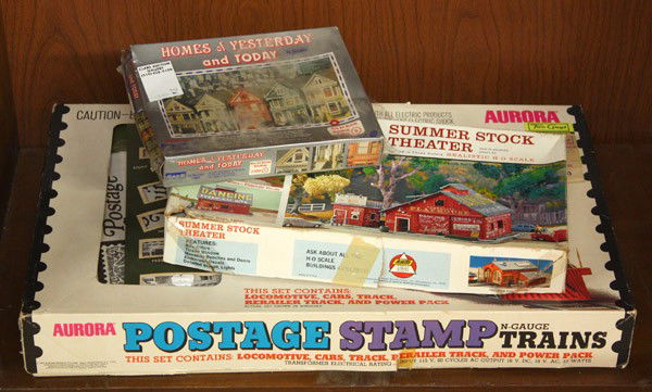 Model railroad accessories: (lot of 3) Model railroad accessories, including a Aurora Postage Stamp N Gauge Train starter set, a box containing 6 N gauge trains and associated track segments, plus one box containing N scale buil