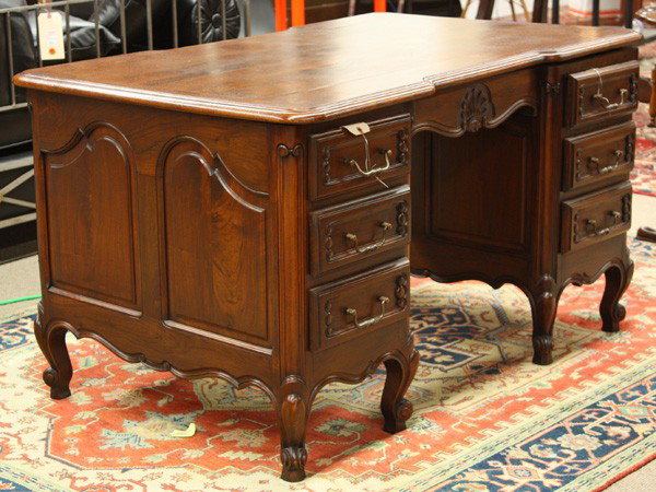 Louis XV style partners desk: Louis XV style partners desk, having a rectangular top above a full panelled case centered with an acanthus carved medallion, one side flanked with doors, and one with two drawer banks, rising on cabr