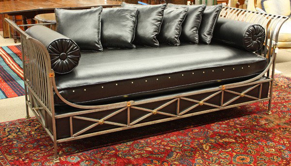 Mid-century wrought steel daybed: Mid-century wrought steel daybed, with Neo-Classical elements, and brass medallions, upholstered in black naugahyde, 33''h x 83''w x 34''d