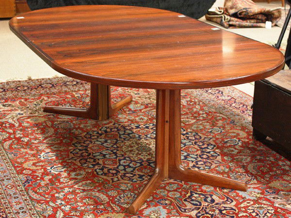 Niels O. Moller Danish rosewood dining table: Niels O. Moller (1920-1982) Danish rosewood dining table, circa 1970, made by Gudme Mobelfabrik, the top with a racetrack form and bullnose edge, raised on two pedestals, marked on the underside Made