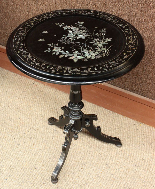 Napoleon III style inlaid tilt top table: Napoleon III style ebonized and inlaid tilt top occasional table, having a floral and fauna mother of pearl inlaid top above the turned standard terminating on a tripod base, 26''h x 22''w