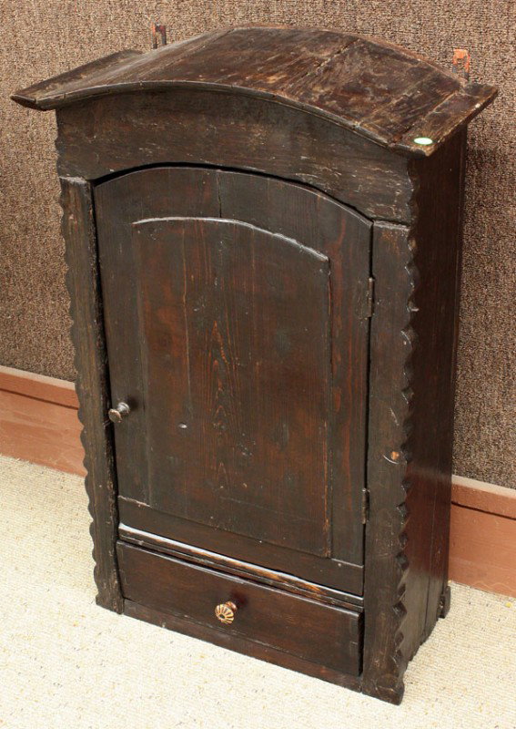 Country style wall cabinet: Continental Primitive style wall cabinet, having an arched crest above the single door case, 33''h x 22''w x 10''d