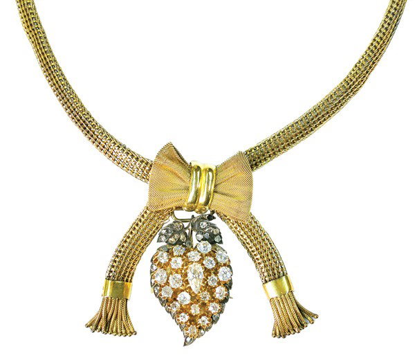 Antique diamond silver yellow gold pendant brooch: Antique cut diamond cluster pendant/brooch combination; silver topped with 14k yellow gold, having rose cut diamond set silver leaves and stem apex, set with (1) pear cut, (21) mixed old mine/European