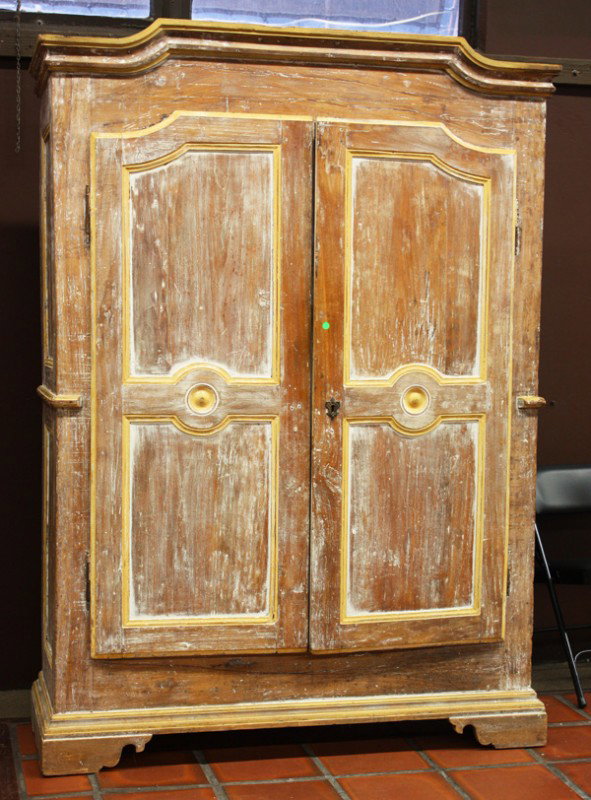 Italian country style linen press: Italian Country style linen press, executed in walnut with a pickled finish and yellow accents, having an ox bow molded cornice above the panelled and molded double doors and rising on bracket feet, 8