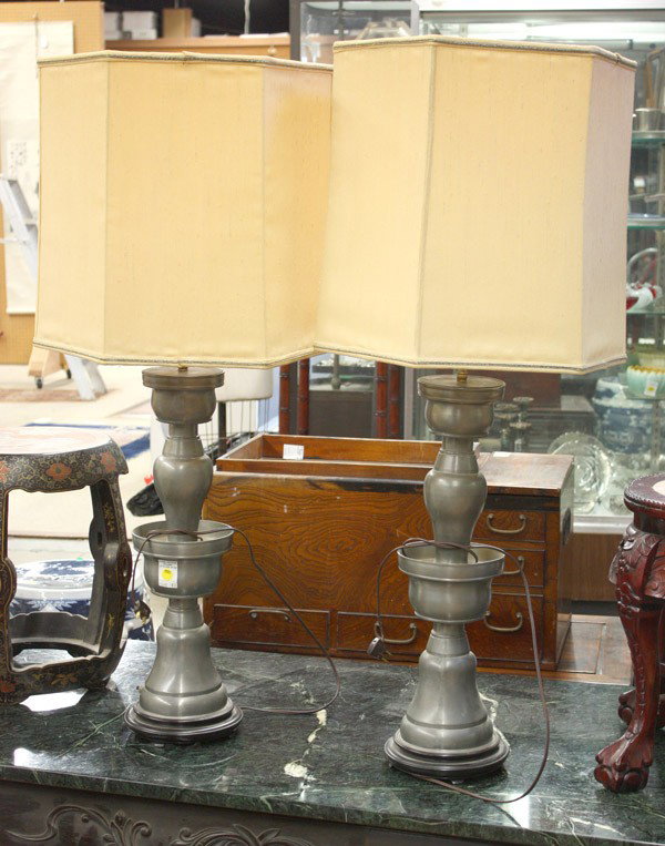 Pair Chinese Pewter Candle Holders (Electrified): Pair of Chinese large pewter lamps in the form of altar candle holders, each with a vasiform upper section supporting a cup-like top, all set within a bowl raised on a high pedestal base, attached woo