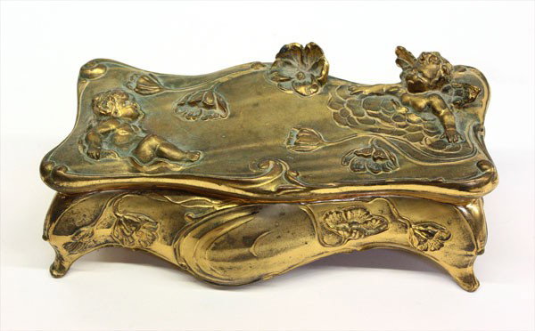 Art Nouveau jewelry casket: Art Nouveau gilt metal casket having flowers and putti in relief with a pink fitted interior, 3.5''h x 9.5''w