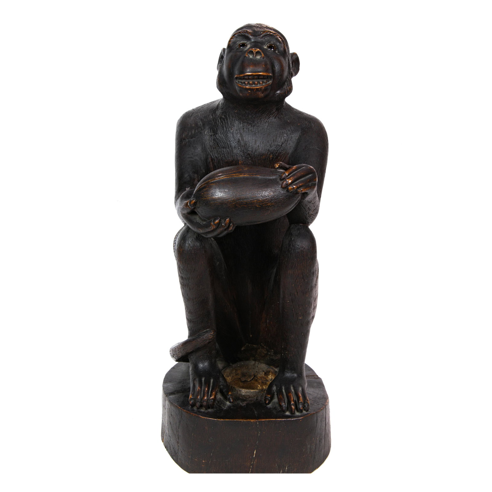 A carved monkey seated with coconut (1 of 4)
