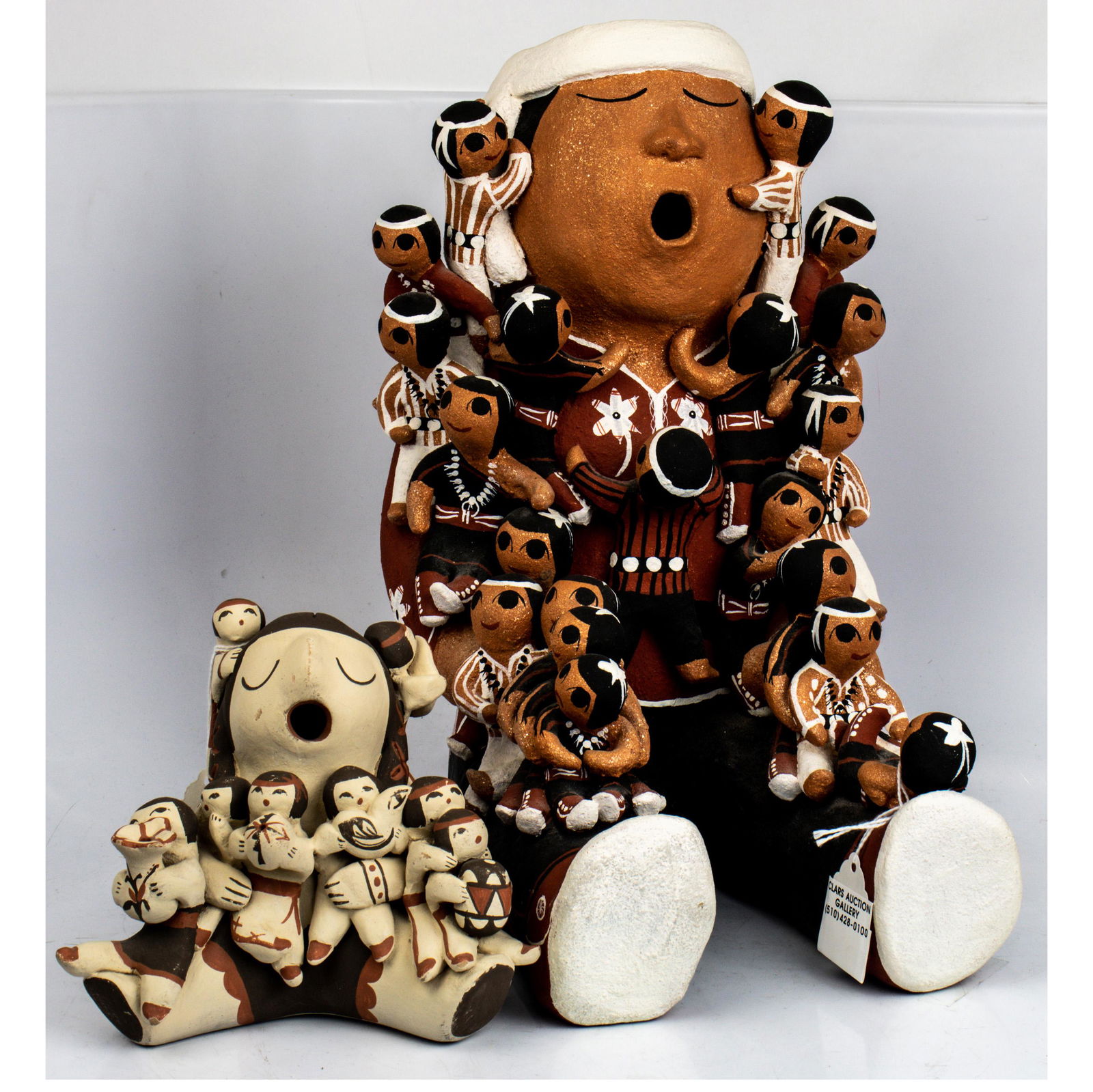 Two Pueblo pottery story teller groups, the first by (1 of 1)