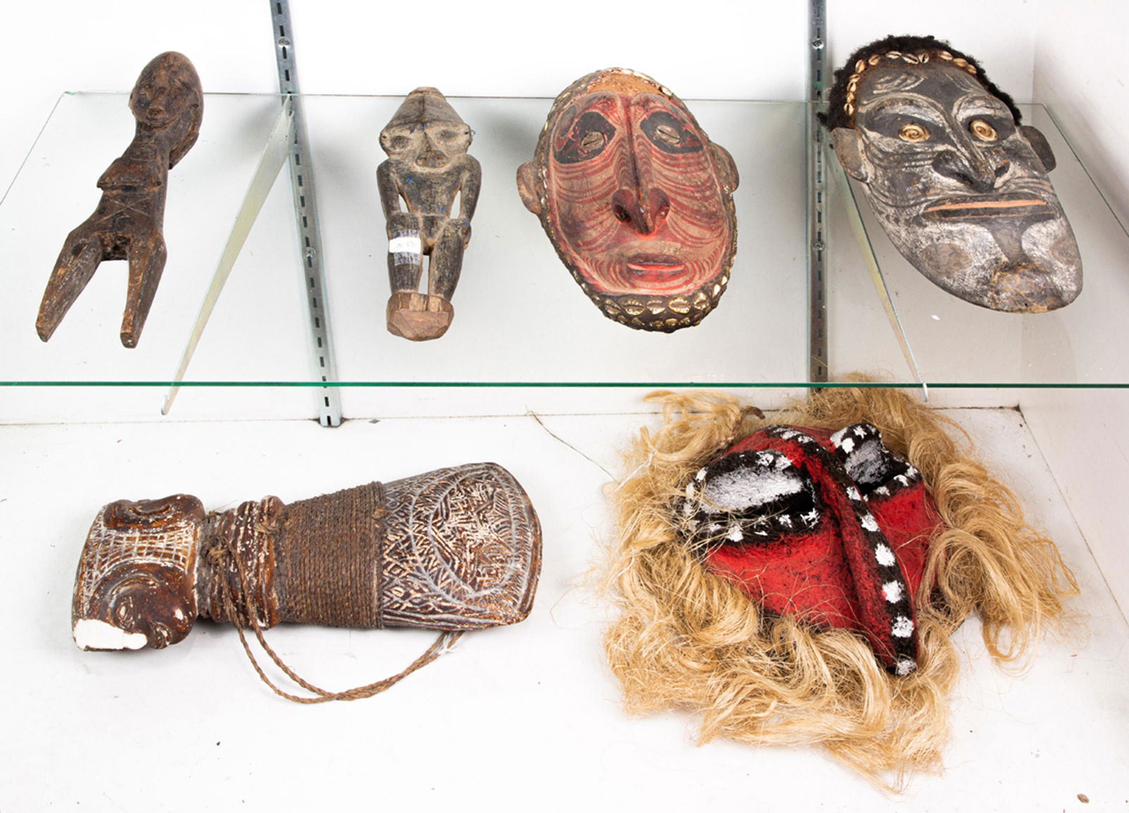 Two shelves of Oceanic and tribal art including (1 of 1)