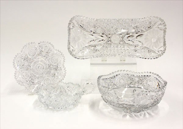 Brilliant cut crystal: (lot of 4) Group of brilliant cut table articles, consisting of a scalloped bowl 8''w, one tray 12.5''w, condiment bowl, and plate, each having a scalloped rim above a geometric cut body
