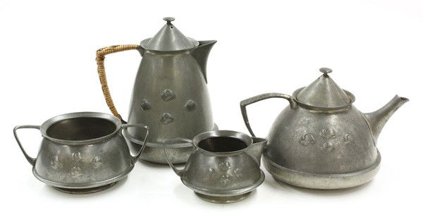 Archibald Knox pewter tea service: Pewter tea set designed by Archibald Knox (1864-1933), cast in relief with reserves of stylised foliage, comprising compressed teapot and hinged cover, cylindrical hot water pot and hinged cover, milk