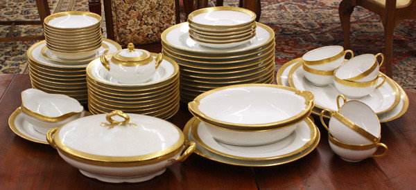 Limoges porcelain gilt table service: (lot of 66) Limoges porcelain table service, C. Ahrenfeldt, Limoges, for S and G Gump Co., San Francisco, CAL., with a white ground, and a gilt border, includes, 12 dinner plates 10'', 10 salad plates