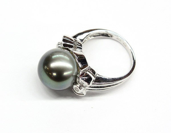 Black Tahitian cultured pearl diamond ring: Black Tahitian cultured pearl and diamond ring; mounted in 18k white gold, set with (1) 13mm black Tahitian cultured pearl and side set on either side with two diamond ''Bow'' accents having (14) bagu