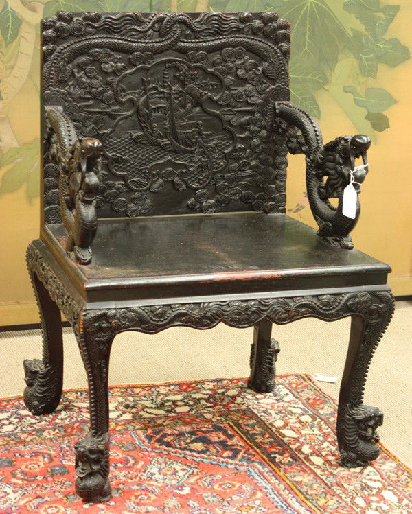 Chinese Ebonized Export Chair, Republic: Chinese ebonized wood armchair, Republic period, the rectangular back splat carved with sails in a shaped reserve silhouetted against dense cloud scrolls below a pair of dragons with entwined tails an