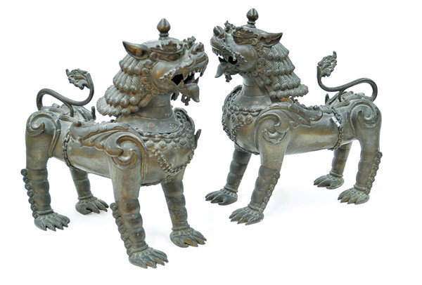 Pair Large Southeast Bronze Chinthe/Lions: Pair of large Southeast Asian patinated bronze chinthe/leogryph, probably 19th century, cast in multiple sections as a male or female lion-like mythical beast standing in a stiff frontal pose, each wi