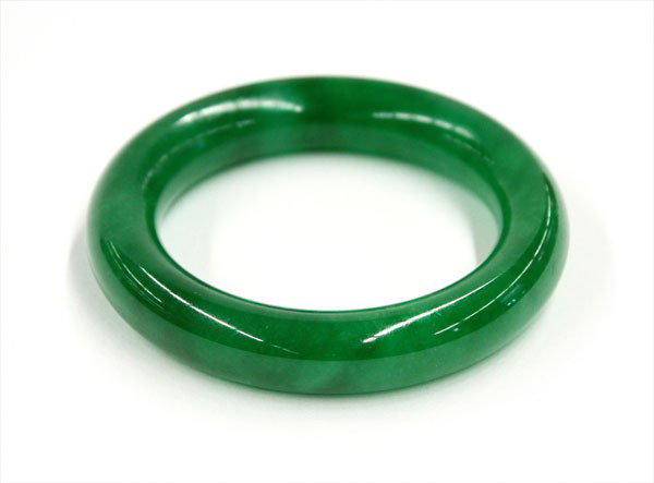 Malaysian Jade Bangle Bracelet: Jade bangle bracelet, reputed to be Malaysian jade, the semi-translucent hoop of an emerald green color mottled with occasional light areas, 3.1'' outer dia