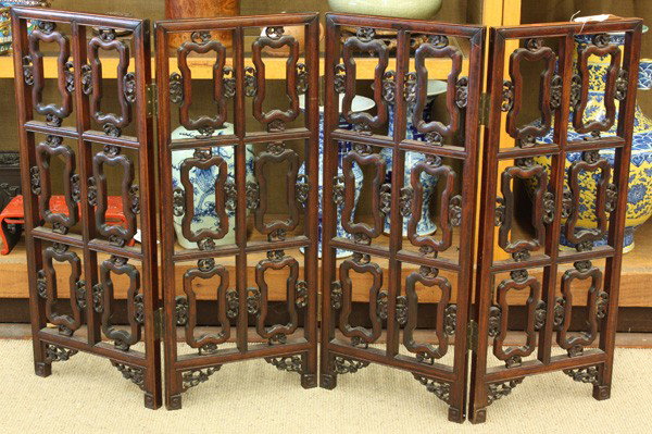Chinese Hardwood Small Reticulated Folding Screen: Chinese small four panel hardwood folding screen, each panel featuring six fan shaped openwork reserves bracketed by pierced florals and raised on scrolling supports accented with prunus-carved spandr
