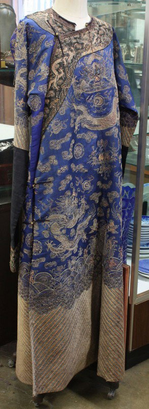 Chinese/Manchu Gilt Embroidered Blue Robe (Jifu),: Manchu embroidered blue silk robe 'jifu', late Qing, the front and back each with three metallic couched dragons in pursuit of sacred jewels on a ground scattered by cloud scrolls, shou medallion and 