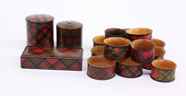 Tartenware match holder, stamp box, napkin rings: (lot of 16) Late 19th century Tartanware including a ''go-to-bed'' match holder, stamp box, and napkin rings