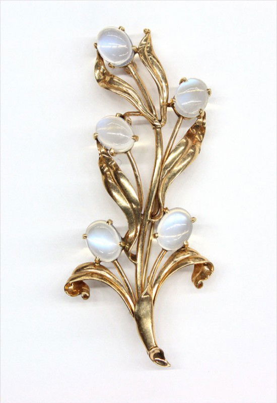 Yellow gold moonstone brooch: Moonstone brooch; mounted in 14k yellow gold, set with (5) oval moonstones measuring 6.94 mm x 9.34 mm. Total pendant weight 10.4 grams