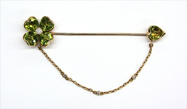 Diamond peridot four leaf clover pin yellow gold: Diamond and peridot ''Four Leaf Clover'' stick pin; of 14k yellow gold, set with (5) heart shaped green peridots and (4) bezel set diamonds. Total pin weight 7.6 grams
