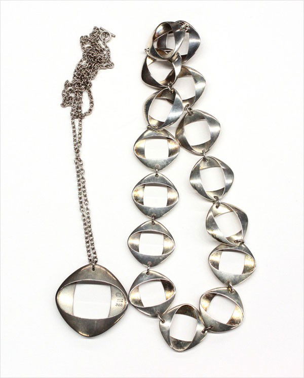 Georg Jensen silver jewelry: Bag of sterling jewelry articles executed by Georg Jensen silversmith, consisting of a necklace and pendant