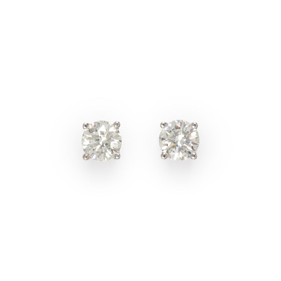 A pair of diamond and fourteen karat white gold stud earrings (1 of 1)