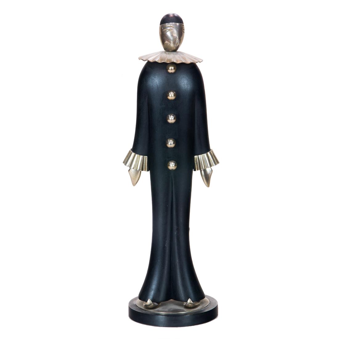 A Modernist silver plate and wood figure of Pierrot: A Modernist silver plate and wood figure of Pierrot, the stylized wood figure mounted with a silver face, a ruffle rim collar, twin sleeves, five ball form buttons and pair pointed slipper shoes, mark