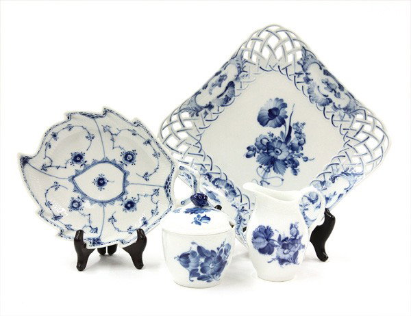 royal Copenhagen porcelain: (Lot of 4) Royal Copenhagen porcelain table articles, each having blue floral decoration on a white ground, consisting of a reticulated serving tray 9'', leaf form condiment tray, and covered sugar wi