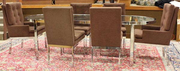 Moderne chrome dining table and chairs, 1970's: (lot of 7) Moderne chrome dining table and chairs, circa 1970, including a glass top racetrack dinning table, supported by a conforming chrome frame, rising on chromed steel legs, includes one extensi