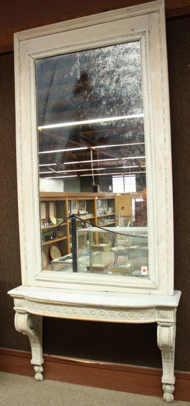 Renaissance style mirrored console: Renaissance style mirrored console, having a rectangular framed looking glass above a shaped marble top rising on the paint decorated and carved support, 91h x 31''w