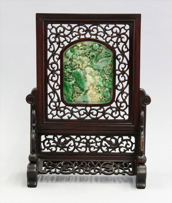Chinese Wooden Table Screen with Jade Plaque: Chinese reticulated wood two-part table screen with a jade plaque, the two-sided mottled green plaque carved and undercut with a phoenix reversed by a crane and deer amid pine and lingzhi, all set wit