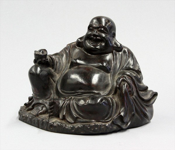 Chinese Hardwood Budai: Chinese stained wood figure of Budai, the Buddhist figure seated in a position of royal ease holding an ingot and clutching a mouth of a large bag, 6.9''w