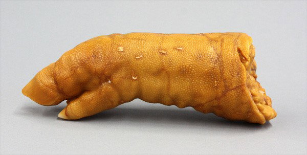 Chinese Soapstone Study of a Pig's Trotter: Chinese yellow soapstone study, realistically rendererd as a pig's trotter with the textured skin incorporating the inclusions of the mustard yellow colored matrix, 7.75''w