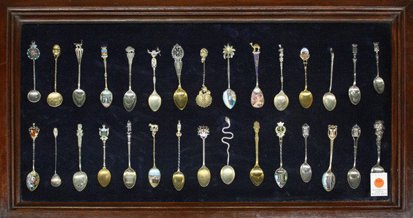 Collection of souvenier spoons: Collection of thirty souvenirs spoons of various European destinations consisting of sterling, .800, and silverplate, some with enamel or gilt decoration, all mounted in a shadow box
