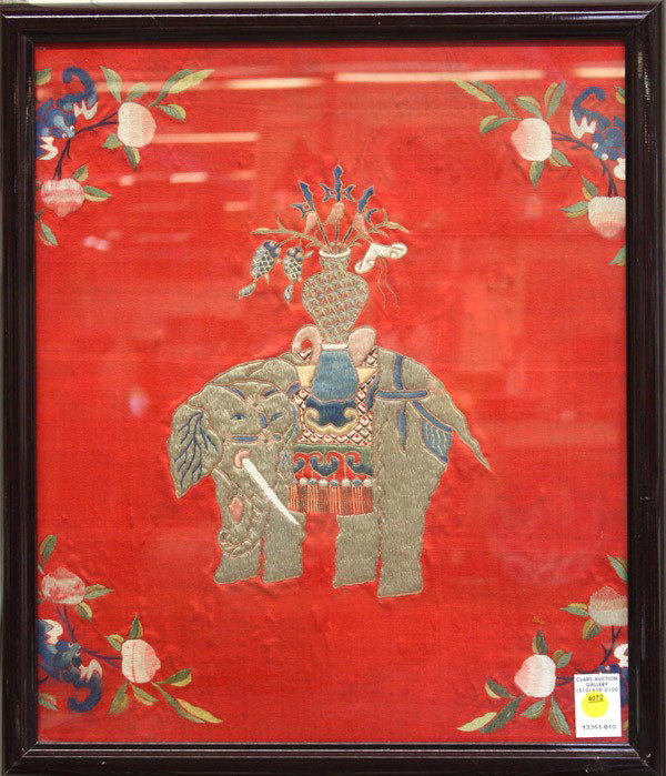 Chinese Silk Textile Panel: Framed Chinese embroidered textile panel, depicting an elephant supporting a vase set with auspicious items, accented with bats and fruiting peach sprigs all on a red ground, 22''h x 19''w