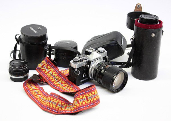 Olympus OM-1 35mm camera outfit: (lot of 3) 0lympus OM-1 3mmm camera outfit, including an Olympus OM-1 body, serial number 997042, a Sigma 39mm-80mm zoom lens f3.5, an Olympus 50mm lens f1.8, and a Tamaron 85mm-210mm zoom lens f4.5, 
