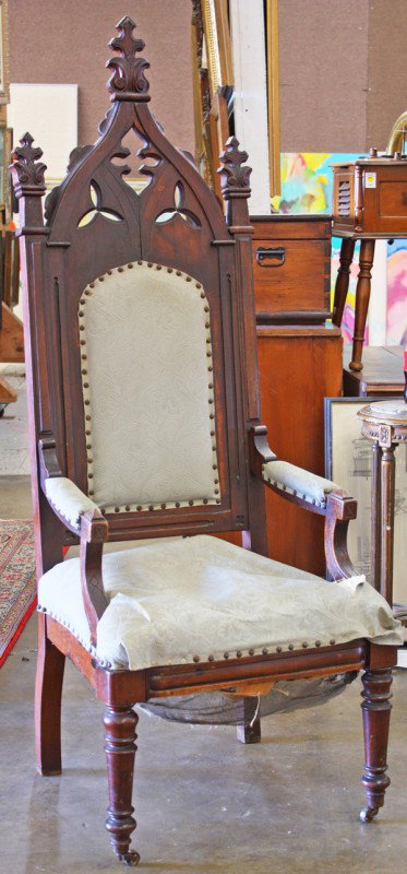 Gothic Revival hall chair: American Gothic Revival hall chair circa 1860, the imposing form having a pierced quatrefoil medallion centering the finial capped stiles, terminating at the incised and outswept returns and rising on