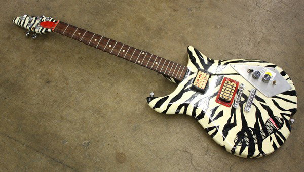 Electric right handed Guitar: Electric right handed guitar, with a zebra body and a rosewood fretboard, overall: 39'h x 13''w