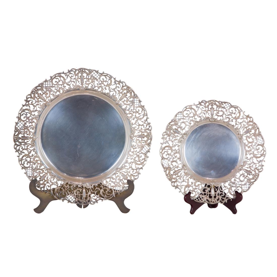 A graduated pair Shreve sterling trays: A graduated pair Shreve & Co sterling trays, fashioned in the Rococo taste, each of dishform enclosing a wide pierced border of rocaille scrollwork, lattice panels and interspersed with flowering urn 