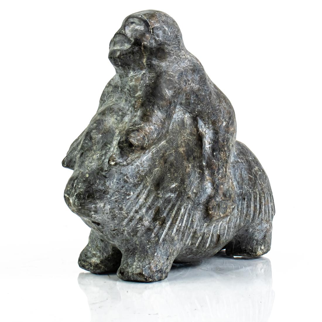 An Inuit basalt figure of man riding a sheep: An Inuit basalt figure of man riding a sheep, 7.5"h x 8.5"w