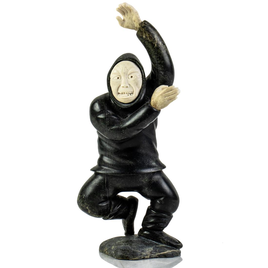 An Inuit green soapstone and bone figure of dancer: An Inuit green soapstone and bone figure of dancer, marked "6C" on base, 9.5"h